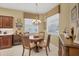 Bright dining area with a wooden table, a chandelier, and lots of natural light at 4121 Reflections Pkwy, Sarasota, FL 34233