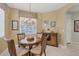 Cozy dining room featuring a round table, chandelier, and natural light at 4121 Reflections Pkwy, Sarasota, FL 34233