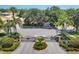 Community entrance with iron gates, mature trees and well-maintained landscaping at 4121 Reflections Pkwy, Sarasota, FL 34233