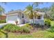 Charming home featuring a well-maintained lawn, landscaping, and a two-car garage at 4121 Reflections Pkwy, Sarasota, FL 34233