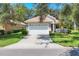 Charming single-story home with a tile roof, a two-car garage, and a well-manicured front yard at 4121 Reflections Pkwy, Sarasota, FL 34233