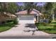 Charming single-story home with a tile roof, a two-car garage, and a well-manicured front yard at 4121 Reflections Pkwy, Sarasota, FL 34233