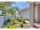 Landscaped front yard with mature trees and shrubs for a welcoming curb appeal at 4121 Reflections Pkwy, Sarasota, FL 34233