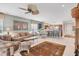 Bright living room featuring a ceiling fan, comfortable seating, and an open floor plan at 4121 Reflections Pkwy, Sarasota, FL 34233