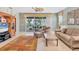 Bright living room featuring sliding glass doors to the outside, comfortable seating, and a ceiling fan at 4121 Reflections Pkwy, Sarasota, FL 34233