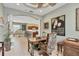 Open-concept space with home office, light tile floors, and views of the kitchen at 4121 Reflections Pkwy, Sarasota, FL 34233