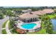 Community pool and spa with covered pavilion and lounge seating in a lush tropical setting at 4121 Reflections Pkwy, Sarasota, FL 34233