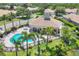 Aerial view of the community pool and spa with tropical landscaping and seating areas at 4121 Reflections Pkwy, Sarasota, FL 34233