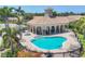 Community pool area with lounge chairs, a spa, and a central gazebo at 4121 Reflections Pkwy, Sarasota, FL 34233