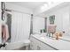 Bathroom featuring a shower/tub combo with a white shower curtain, modern vanity, and neutral decor at 4253 Prairie View Dr, Sarasota, FL 34232