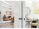 Stylized makeup vanity with bright lighting and fun decor offset with a glimpse into the living room at 4253 Prairie View Dr, Sarasota, FL 34232