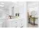 Bright bathroom featuring a white vanity, stylish mirror, decor, and a glimpse of the makeup vanity at 4253 Prairie View Dr, Sarasota, FL 34232