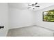 Bright bedroom features tile flooring, ceiling fan, and a window offering natural light at 4253 Prairie View Dr, Sarasota, FL 34232