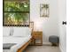 Bright bedroom features neutral wooden bed, side table, and tropical decor to bring nature indoors at 4253 Prairie View Dr, Sarasota, FL 34232