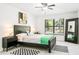 Nicely decorated bedroom featuring a ceiling fan, modern artwork, and black-and-white rugs at 4253 Prairie View Dr, Sarasota, FL 34232