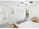 Bright bedroom featuring a natural wood bed, tropical decor, and a large closet at 4253 Prairie View Dr, Sarasota, FL 34232
