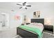 Comfortable bedroom with black furnishings, ceiling fan, natural light, and modern art at 4253 Prairie View Dr, Sarasota, FL 34232