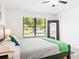 Bright bedroom featuring a ceiling fan, modern décor, and a large window at 4253 Prairie View Dr, Sarasota, FL 34232