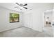 Well-lit bedroom features tile flooring, ceiling fan, closet, and a window at 4253 Prairie View Dr, Sarasota, FL 34232