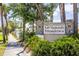 Stone entrance sign for McIntosh Meadows, framed by greenery and a sidewalk at 4253 Prairie View Dr, Sarasota, FL 34232