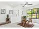 Cozy dining area featuring a round glass table, bamboo chairs, and natural light from a large window at 4253 Prairie View Dr, Sarasota, FL 34232