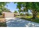 Long driveway leading to a single-story home with a two-car garage and a spacious backyard at 4253 Prairie View Dr, Sarasota, FL 34232