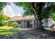 Back exterior of a home featuring a screen patio and lush trees at 4253 Prairie View Dr, Sarasota, FL 34232