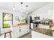 Well-lit kitchen featuring granite countertops, stainless appliances, and a wooden island at 4253 Prairie View Dr, Sarasota, FL 34232