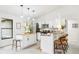 Spacious kitchen featuring a breakfast bar with stools, pendant lighting, and stainless steel appliances at 4253 Prairie View Dr, Sarasota, FL 34232