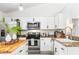 Bright kitchen featuring stainless steel appliances, granite countertops, and white cabinetry at 4253 Prairie View Dr, Sarasota, FL 34232