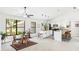 Open-concept kitchen featuring white cabinets, a breakfast bar, and a view of the dining area at 4253 Prairie View Dr, Sarasota, FL 34232