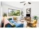 Bright living room with a blue sofa, large windows, and stylish decor at 4253 Prairie View Dr, Sarasota, FL 34232