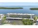 An aerial shot of a large condo complex, highlighting the parking and the close proximity to the water at 4310 Falmouth Dr # 307, Longboat Key, FL 34228