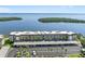 An aerial shot of a large condo complex, highlighting the parking and the close proximity to the water at 4310 Falmouth Dr # 307, Longboat Key, FL 34228