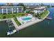 Aerial view of the community pool, boat slips and lush landscaping at 4310 Falmouth Dr # 307, Longboat Key, FL 34228