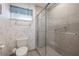 Nicely tiled bathroom featuring a glass enclosed shower and neutral wall paper at 4310 Falmouth Dr # 307, Longboat Key, FL 34228