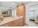 Well-lit bathroom with solid surface vanity, and door to bedroom at 4310 Falmouth Dr # 307, Longboat Key, FL 34228