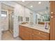 Well-lit bathroom with granite vanity, tile floor, shower and stylish decor at 4310 Falmouth Dr # 307, Longboat Key, FL 34228