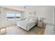 Bright bedroom with neutral decor, wood floors, large window offering scenic water views and furnishings at 4310 Falmouth Dr # 307, Longboat Key, FL 34228