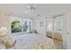 Bright bedroom with ceiling fan, large window, and mirrored closet doors at 4310 Falmouth Dr # 307, Longboat Key, FL 34228