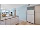 Kitchen featuring granite countertops and modern appliances, open to a sunroom with beautiful views at 4310 Falmouth Dr # 307, Longboat Key, FL 34228