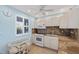 A well-lit kitchen featuring granite countertops, white cabinets, and modern appliances, perfect for culinary enthusiasts at 4310 Falmouth Dr # 307, Longboat Key, FL 34228