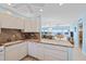 Well-lit kitchen features granite countertops, white cabinets, and an open layout to the dining and living area at 4310 Falmouth Dr # 307, Longboat Key, FL 34228