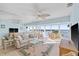 Waterfront living room with neutral décor, comfortable seating, tile floors, water view and sliding doors to outdoor balcony at 4310 Falmouth Dr # 307, Longboat Key, FL 34228