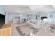 Well-lit living room featuring open layout with dining area, comfortable seating, neutral decor, and water views at 4310 Falmouth Dr # 307, Longboat Key, FL 34228