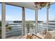 Sunroom featuring sliding glass doors with beautiful bay views, rattan seating, and tile flooring at 4310 Falmouth Dr # 307, Longboat Key, FL 34228