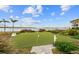 Putting green surrounded by lush landscaping and waterfront view at 4310 Falmouth Dr # 307, Longboat Key, FL 34228