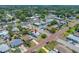 Aerial view of property in residential area with tree coverage and brick roads, showcasing neighborhood and nearby businesses at 440 42Nd N St, St Petersburg, FL 33713