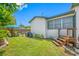 Lush backyard featuring a small deck, grill, and green grass at 440 42Nd N St, St Petersburg, FL 33713