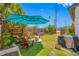 Expansive backyard featuring a patio area with comfortable seating and a vibrant blue umbrella at 440 42Nd N St, St Petersburg, FL 33713